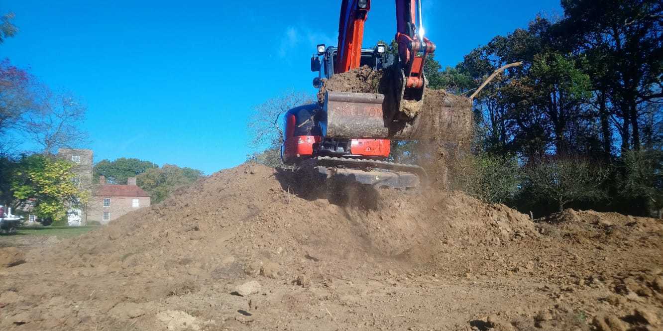 digger on large earth mound